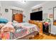 Inviting bedroom with a large bed, dark wood furniture, and bright natural light at 606 Memorial Dr, Beech Grove, IN 46107