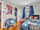 Cozy bedroom features hardwood floors, a large poster, and closet for storage at 606 Memorial Dr, Beech Grove, IN 46107