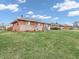 A well maintained single story brick house with an expansive front lawn at 606 Memorial Dr, Beech Grove, IN 46107