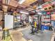 View of the garage with storage shelves, gym equipment, and a white refrigerator at 606 Memorial Dr, Beech Grove, IN 46107