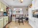 Charming kitchen with tile flooring, updated appliances, and a cozy dining area bathed in natural light at 606 Memorial Dr, Beech Grove, IN 46107