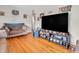 Spacious living room featuring hardwood floors, neutral walls, and a large flat-screen TV, perfect for entertaining at 606 Memorial Dr, Beech Grove, IN 46107