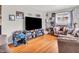 Comfortable living room with a large TV, hardwood floors, and cozy seating, creating a warm and inviting atmosphere at 606 Memorial Dr, Beech Grove, IN 46107