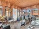 Bright sunroom features wood paneled ceiling and walls, many windows, and a door to the exterior at 606 Memorial Dr, Beech Grove, IN 46107