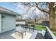 A spacious back deck provides a serene outdoor living space with chairs, string lights, and a lovely bench at 6179 Norwaldo Ave, Indianapolis, IN 46220