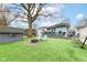 A beautiful backyard with a fire pit, hammock, shed, and well-maintained lawn at 6179 Norwaldo Ave, Indianapolis, IN 46220