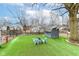 A well-maintained backyard features lush green grass and cozy sitting area around a fire pit at 6179 Norwaldo Ave, Indianapolis, IN 46220