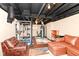 Finished basement featuring home gym area with weightlifting equipment and comfortable seating at 6179 Norwaldo Ave, Indianapolis, IN 46220