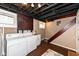 Functional basement laundry area with washer, dryer, utility sink, and painted ceiling beams at 6179 Norwaldo Ave, Indianapolis, IN 46220