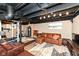 Relaxing finished basement with a comfortable leather couch and punching bag fitness area at 6179 Norwaldo Ave, Indianapolis, IN 46220