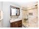 Renovated bathroom featuring a walk-in tiled shower with glass enclosure and a stylish vanity at 6179 Norwaldo Ave, Indianapolis, IN 46220