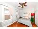 Bright bedroom with hardwood floors, a ceiling fan, neutral walls, and a comfy queen bed at 6179 Norwaldo Ave, Indianapolis, IN 46220
