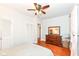This cozy bedroom has wood floors, a ceiling fan, and a dresser with a large mirror at 6179 Norwaldo Ave, Indianapolis, IN 46220