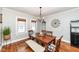 Cozy dining room featuring a wooden table, bench seating, hardwood floors and an ornate chandelier at 6179 Norwaldo Ave, Indianapolis, IN 46220