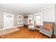 Bright living room features hardwood flooring, neutral walls, and charming windows at 6179 Norwaldo Ave, Indianapolis, IN 46220