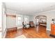 Well-lit living area with hardwood floors flowing into an adjacent dining space at 6179 Norwaldo Ave, Indianapolis, IN 46220