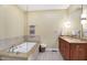 Spa bathroom with a soaking tub, and vanity with neutral tile surround at 645 E 9Th St, Indianapolis, IN 46202