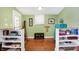 Open entryway with light green walls, beautiful wood floors, and unique decorative touches at 645 E 9Th St, Indianapolis, IN 46202