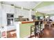 Gourmet kitchen featuring stainless steel appliances, custom cabinetry, and a breakfast bar connecting to the dining area at 645 E 9Th St, Indianapolis, IN 46202
