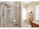Modern bathroom showcasing a glass-enclosed shower, white stool, and built in shelving at 645 E 9Th St, Indianapolis, IN 46202