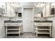 Elegant bathroom featuring dual vanities with a door that separates the two, all highlighted by clean, white cabinetry at 6560 Dawson Lake Dr, Indianapolis, IN 46220