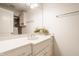 Well-lit bathroom featuring a vanity with a countertop sink, an overhead mirror, and chrome fixtures at 6560 Dawson Lake Dr, Indianapolis, IN 46220