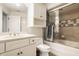 Well-lit bathroom featuring a vanity with a countertop sink, a toilet, and a shower with a glass door at 6560 Dawson Lake Dr, Indianapolis, IN 46220