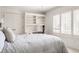 Comfortable bedroom with a queen bed, a built-in desk, and a window with shutter blinds at 6560 Dawson Lake Dr, Indianapolis, IN 46220