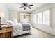 Cozy bedroom with a bed and a built-in desk, complemented by natural light streaming through shuttered windows at 6560 Dawson Lake Dr, Indianapolis, IN 46220