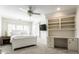 Inviting bedroom featuring a built-in desk and shelving alongside a plush bed, illuminated by a ceiling fan at 6560 Dawson Lake Dr, Indianapolis, IN 46220