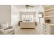 Comfortable bedroom with a queen bed, built-in bookshelves, and a large window with shutter blinds at 6560 Dawson Lake Dr, Indianapolis, IN 46220