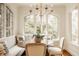Bright breakfast nook featuring banquette seating, a chandelier, and lots of natural light at 6560 Dawson Lake Dr, Indianapolis, IN 46220