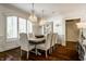 Formal dining room featuring hardwood floors, shuttered windows, and elegant chandeliers at 6560 Dawson Lake Dr, Indianapolis, IN 46220