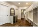 Entryway that flows past a wine fridge into a hallway with custom storage, blending convenience with style at 6560 Dawson Lake Dr, Indianapolis, IN 46220