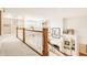 Bright hallway with built-in bookshelves, decorative columns, and staircase leading to the lower level at 6560 Dawson Lake Dr, Indianapolis, IN 46220