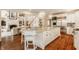 Spacious white kitchen featuring a large island with seating and stainless steel appliances at 6560 Dawson Lake Dr, Indianapolis, IN 46220