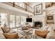 Expansive living room with a stone fireplace, built-in shelves, and access to the outdoor deck at 6560 Dawson Lake Dr, Indianapolis, IN 46220