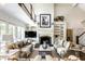 Elegant living room featuring a fireplace, built-in bookshelves, and a grand two-story ceiling at 6560 Dawson Lake Dr, Indianapolis, IN 46220