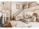 Spacious living area showcasing a staircase, fireplace, hardwood floors, and open access to the kitchen at 6560 Dawson Lake Dr, Indianapolis, IN 46220