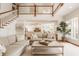 Inviting living room featuring a staircase, hardwood floors, and an open view to the kitchen at 6560 Dawson Lake Dr, Indianapolis, IN 46220
