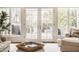 Comfortable living room with French doors leading to the outdoors and cozy seating arrangements at 6560 Dawson Lake Dr, Indianapolis, IN 46220