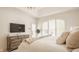 Cozy primary bedroom with neutral tones, large windows, and a dresser for ample storage space at 6560 Dawson Lake Dr, Indianapolis, IN 46220