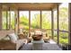 Relaxing screened porch with wicker furniture and views of the backyard at 6560 Dawson Lake Dr, Indianapolis, IN 46220