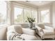 Cozy sitting room with lots of natural light, comfortable chairs, and a table with a vase of flowers at 6560 Dawson Lake Dr, Indianapolis, IN 46220