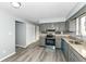 Modern kitchen with stainless steel appliances, granite countertops, gray cabinets, and sleek flooring at 7322 S Sherman Dr, Indianapolis, IN 46237