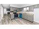 Updated kitchen with stainless steel appliances, granite countertops, gray cabinets, and sleek flooring at 7322 S Sherman Dr, Indianapolis, IN 46237