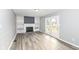 Inviting living room with a brick fireplace, built-in shelving, and easy access to the patio at 7322 S Sherman Dr, Indianapolis, IN 46237