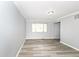 Spacious living room featuring sleek floors, neutral walls, and ample natural light from a large window at 7322 S Sherman Dr, Indianapolis, IN 46237