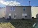 Rear view of the property showcasing a door to the backyard, chairs, a fire pit and manicured lawn at 8360 S Evening Dr, Pendleton, IN 46064