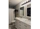 Bathroom featuring a white vanity, double mirror, and a shower tub combo at 8360 S Evening Dr, Pendleton, IN 46064